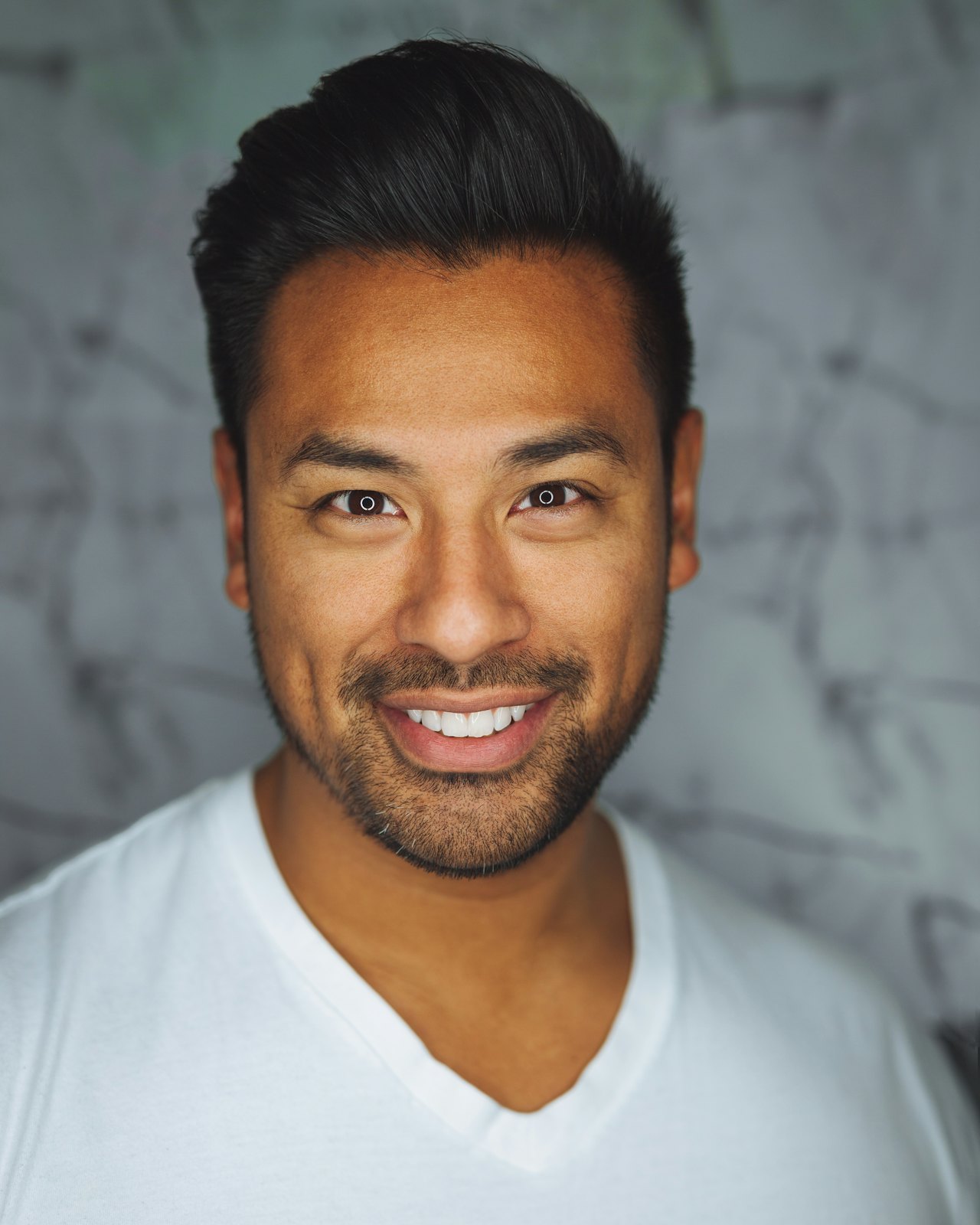 Portrait of a smiling man in a white T-shirt